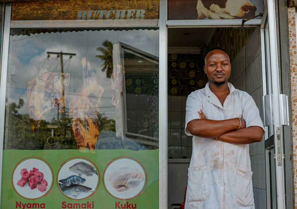 Shop owner standing at the door of his high-street shop